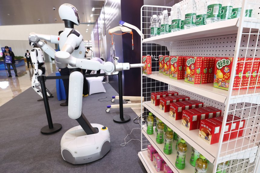 Человекоподобный робот принимает продукцию во время второго этапа испытаний робота с применением встроенного интеллекта в Чжунгуаньцуне.